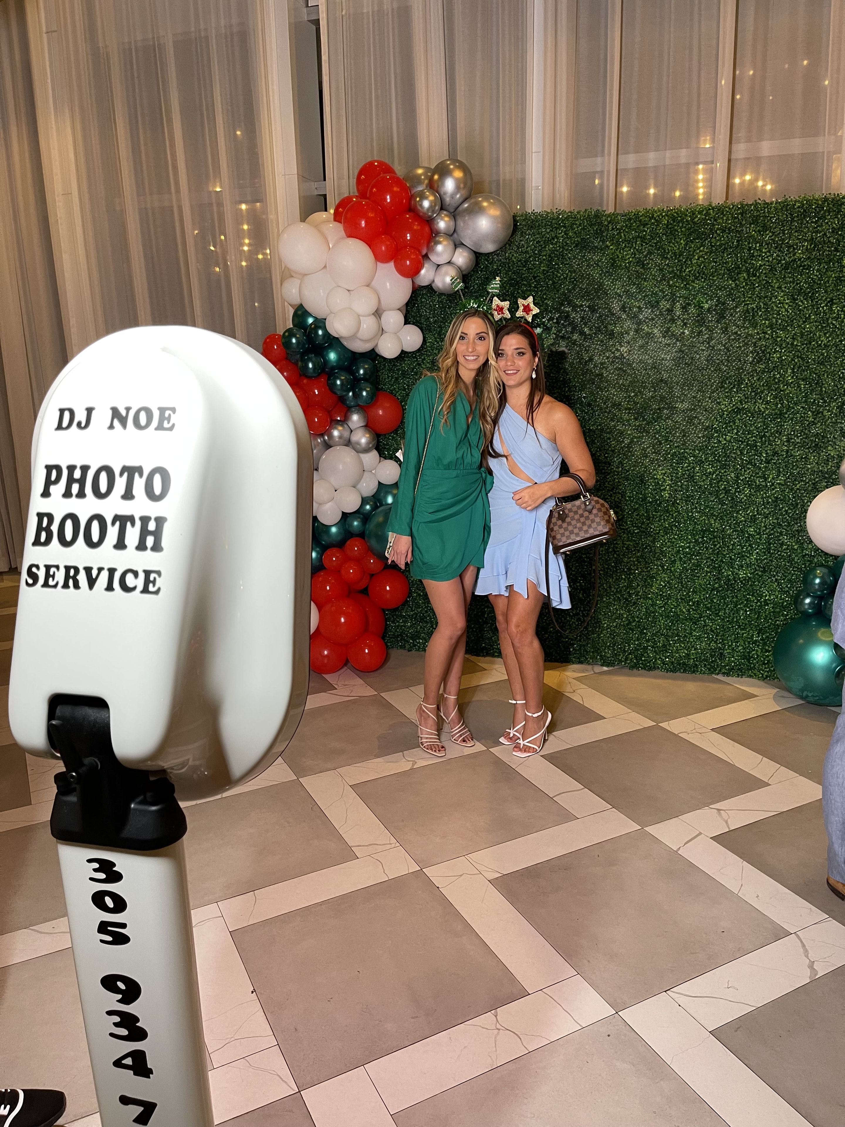 Guests posing at the DJ NOE Photo Booth with interactive touch screen at a real event